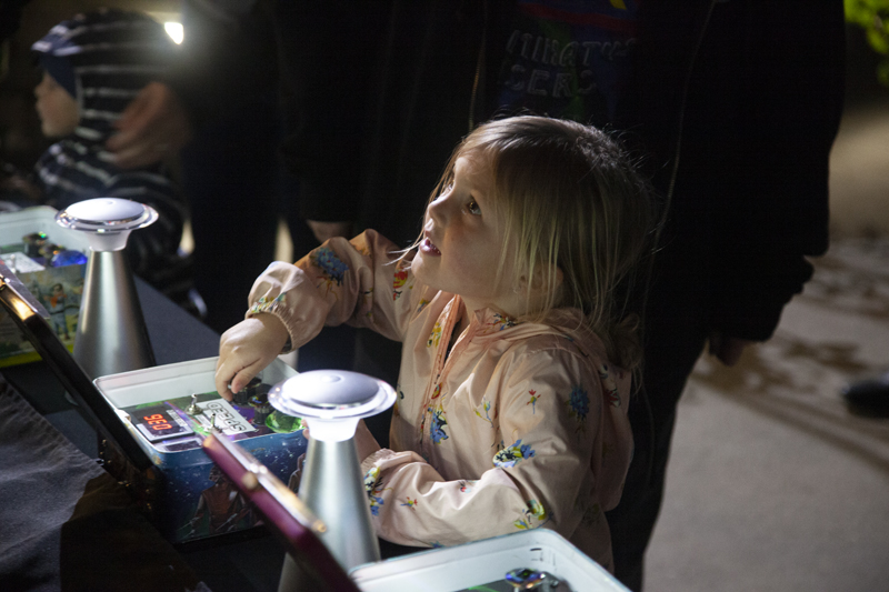 Visitor controlling laser art at Napa Lighted Arts Festival